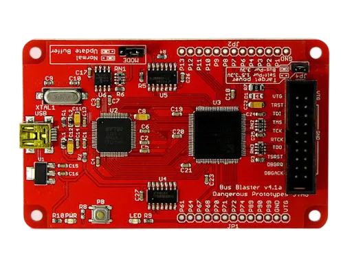 Erik Homma at his workbench surrounded by hardware hacking tools and legacy devices